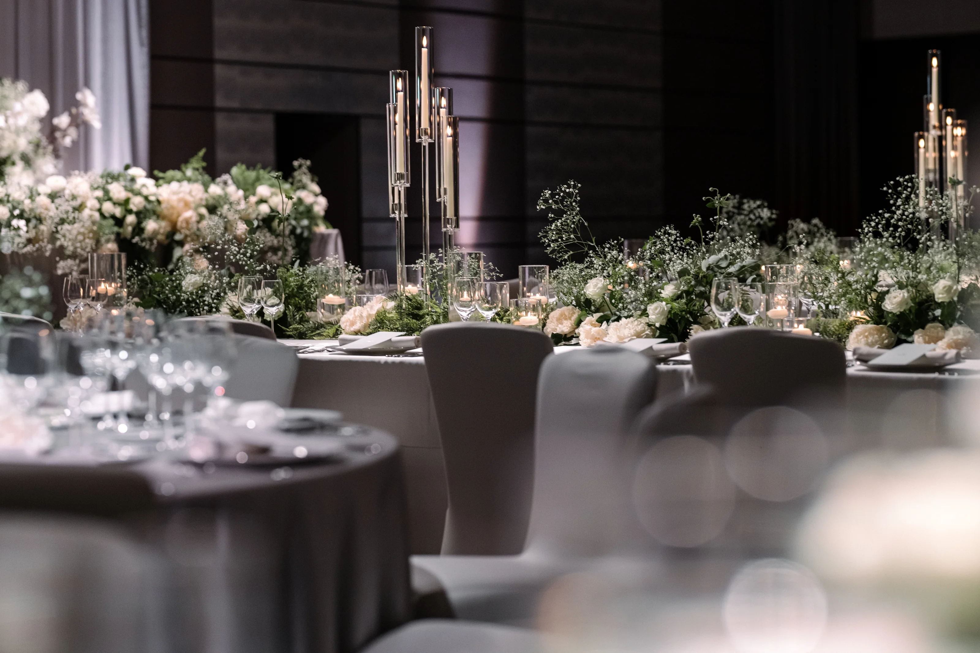 Tall glass candelabras and white flowers run the length of the reception tables at Four Seasons Otemachi in Tokyo.
