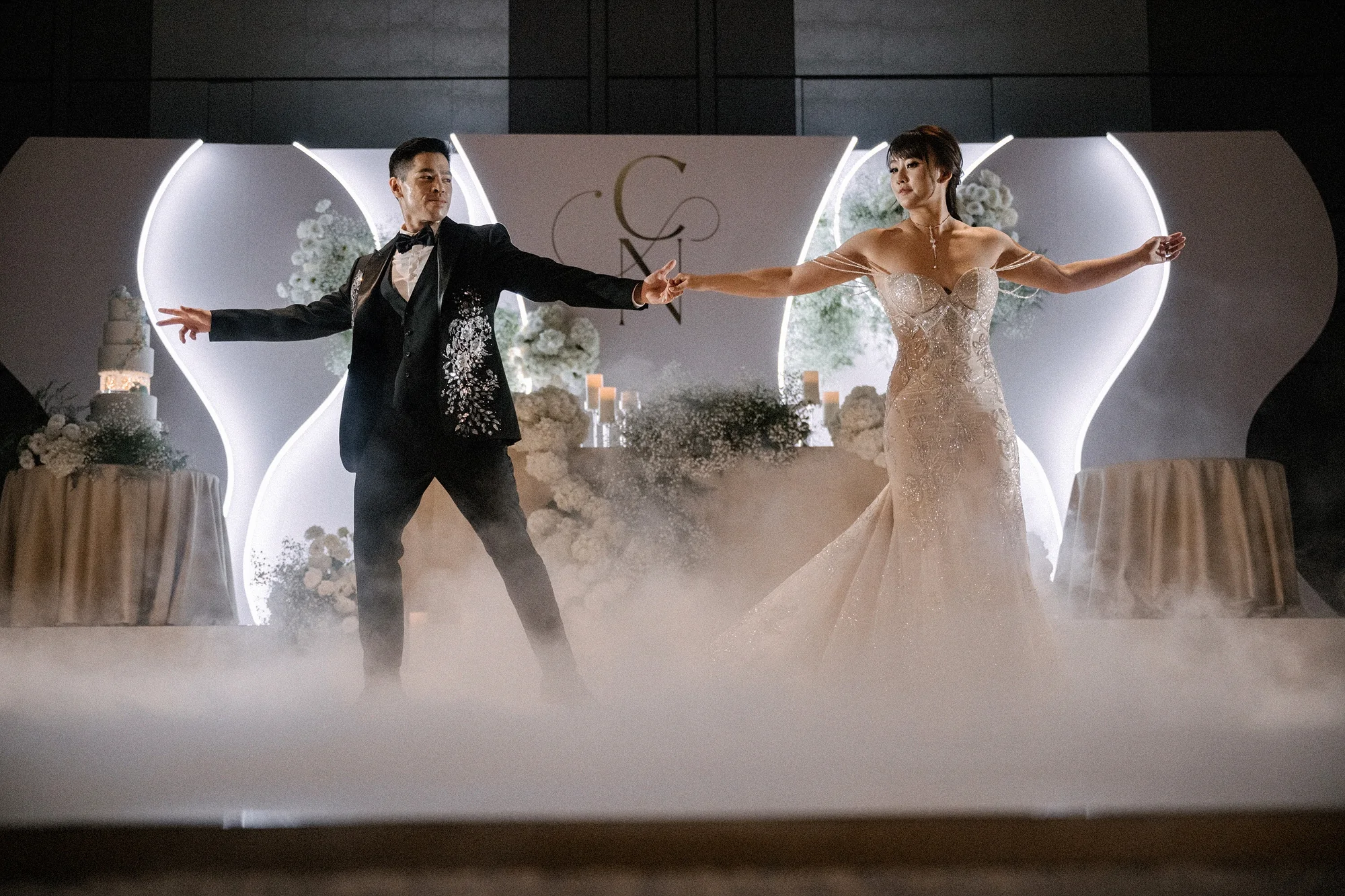 The couple share their first dance through low smoke at Four Seasons Otemachi in Tokyo.