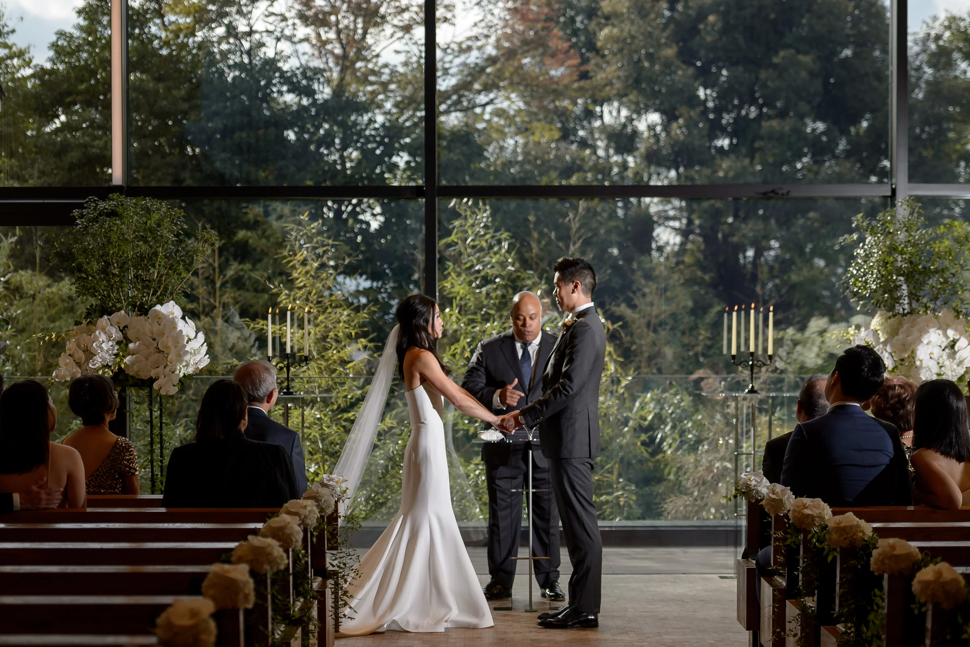 The couple exchange vows in a glass chapel that opens onto green trees in Kyoto.