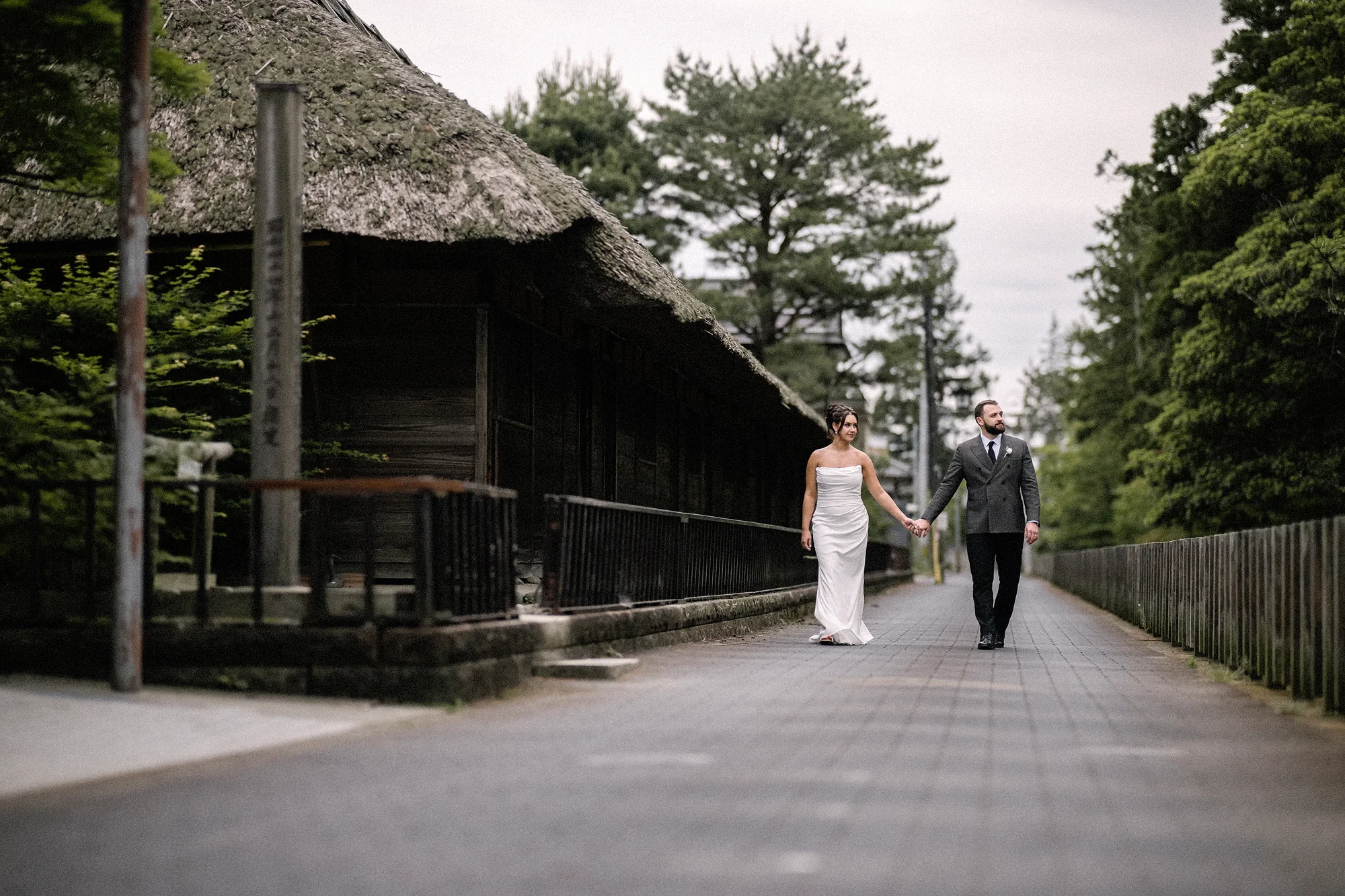 The couple walk along a street of thatched farmhouses in Niigata.