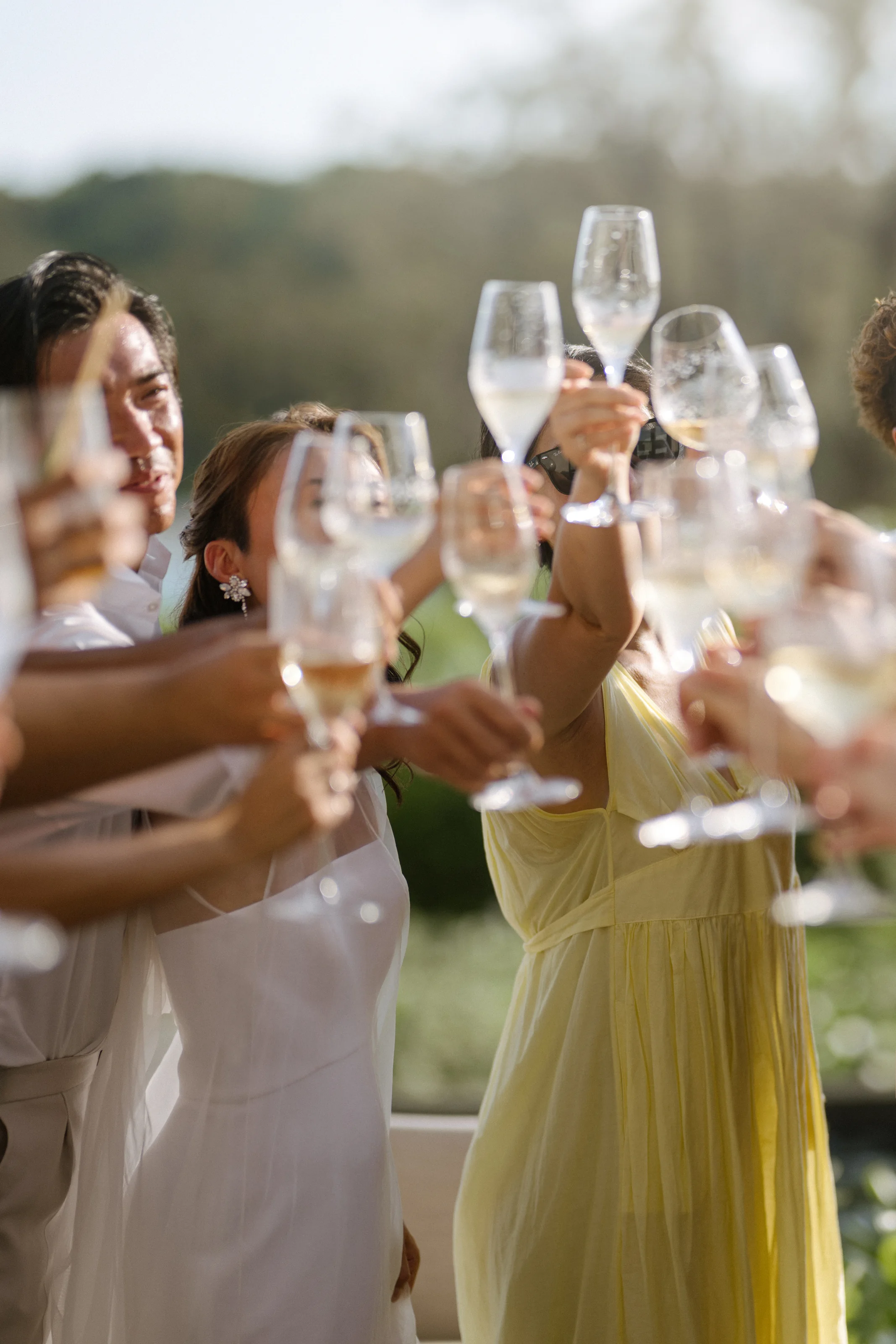 Friends raise their glasses together in the afternoon sun at Rosewood Miyakojima.