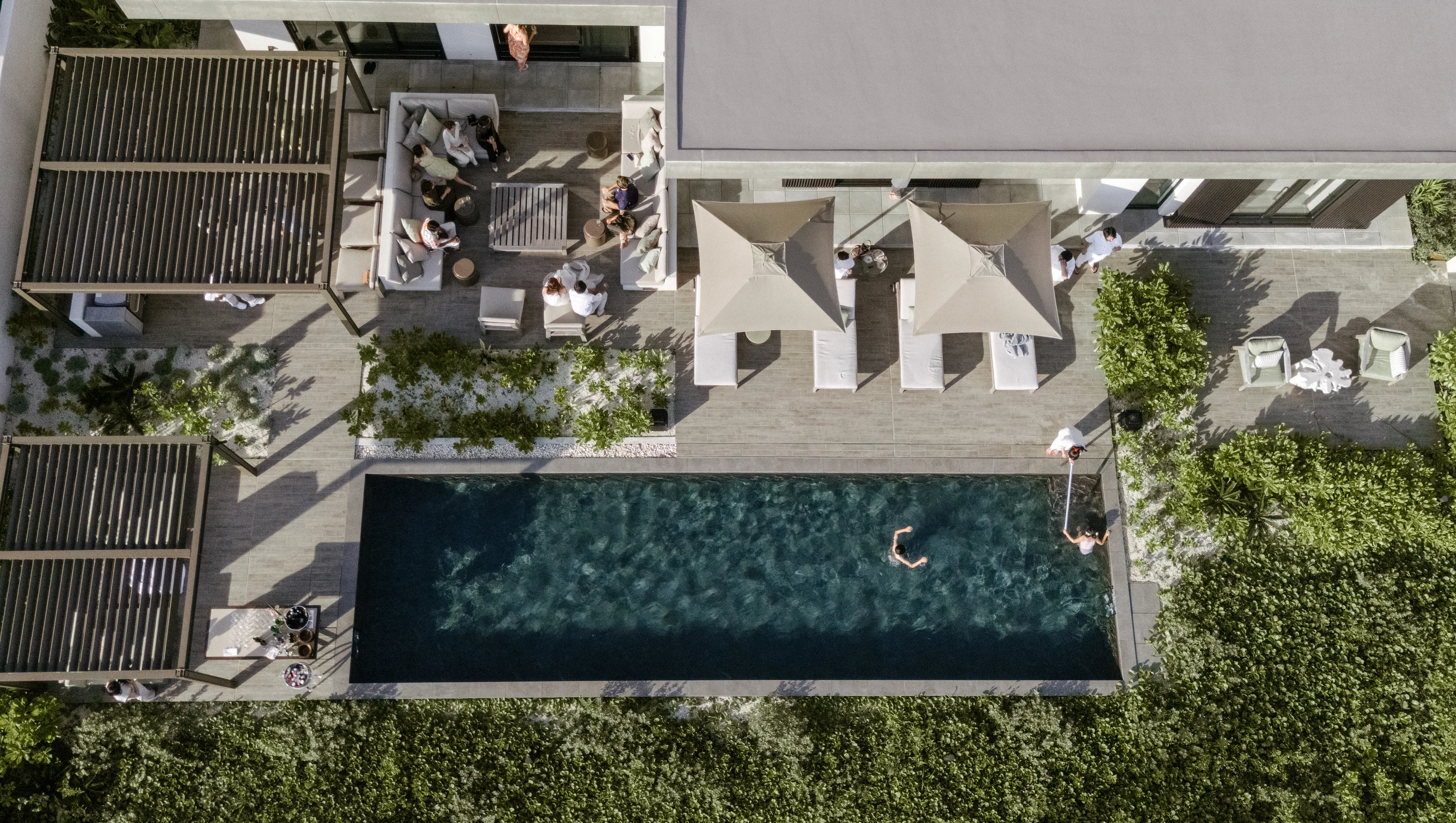 From above, a villa and its pool among gardens at Rosewood Miyakojima.