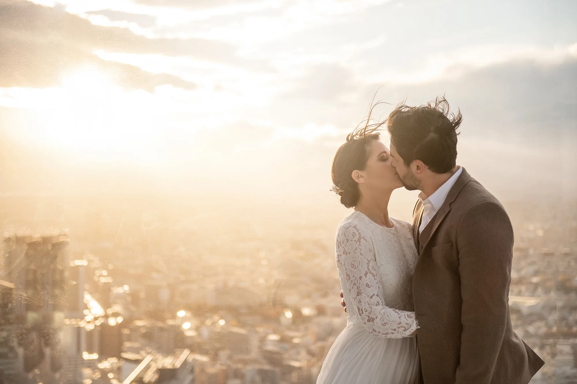 A couple kiss at sunset high above Tokyo.